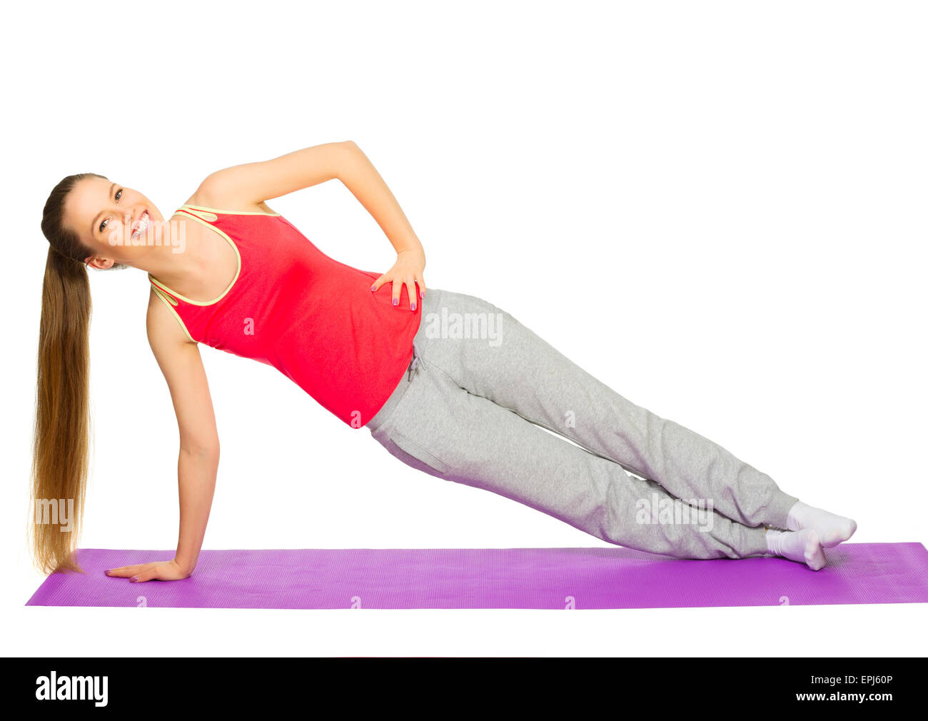 Jeune fille sportive faisant des exercices de gymnastique isolé Banque D'Images