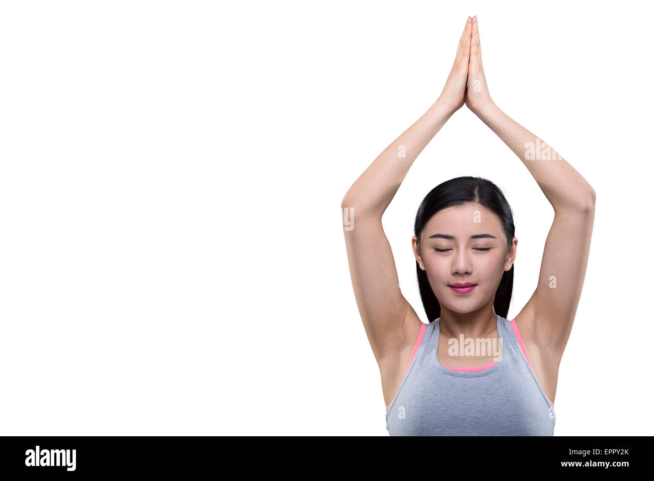 Young woman smiling avec les mains au-dessus de la tête Banque D'Images