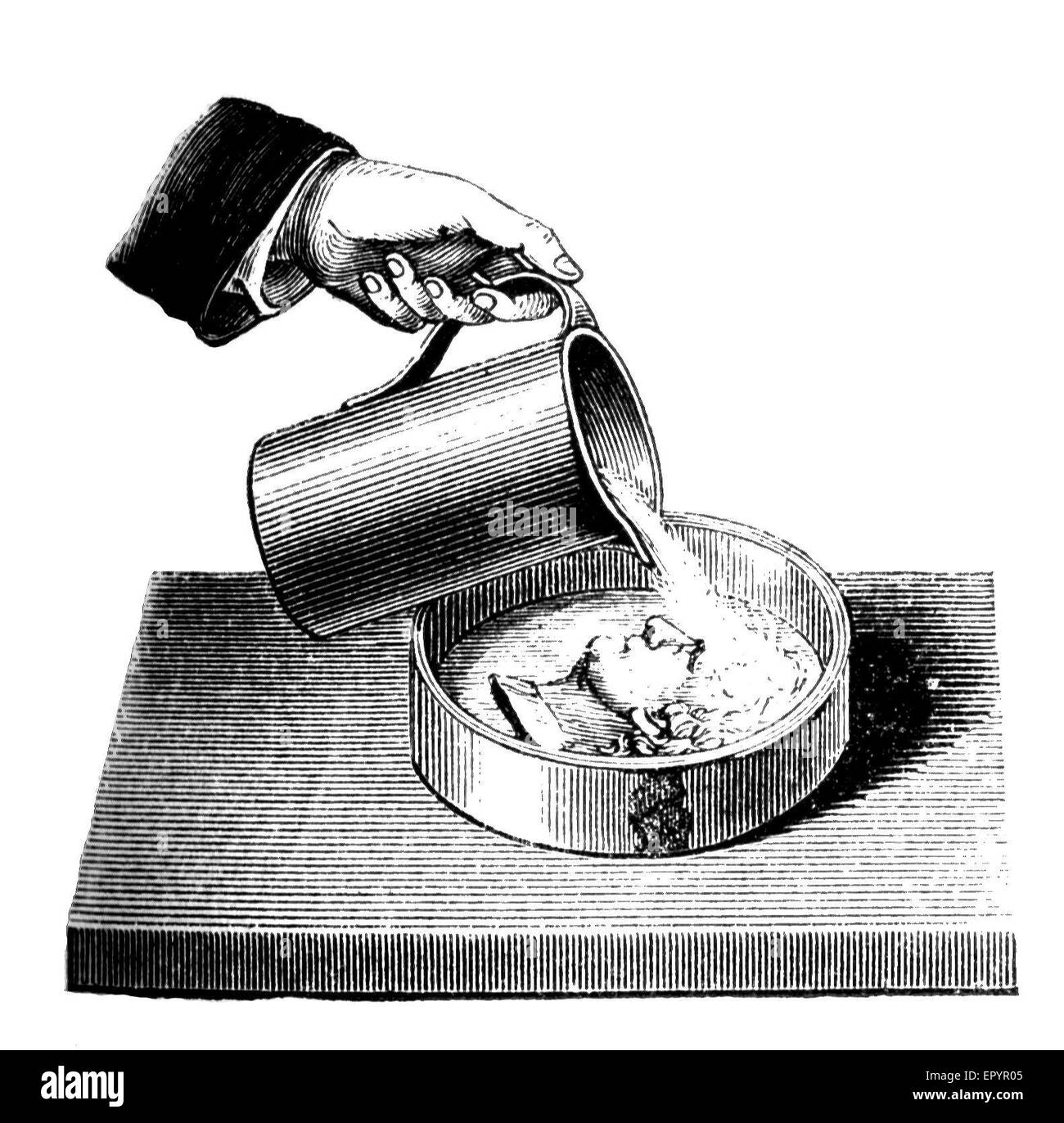 Vintage, cheminstry le moule de coulée d'une pièce (Thaler) avec un mélange d'eau et de gypse (CaSO4  + H2O) Banque D'Images