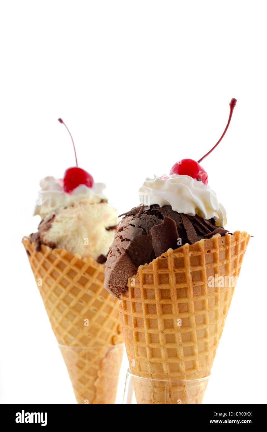 Concept d'été et chocolat glace vanille wafer cone de crème fouettée et de cerises avec queue sur le dessus. Banque D'Images