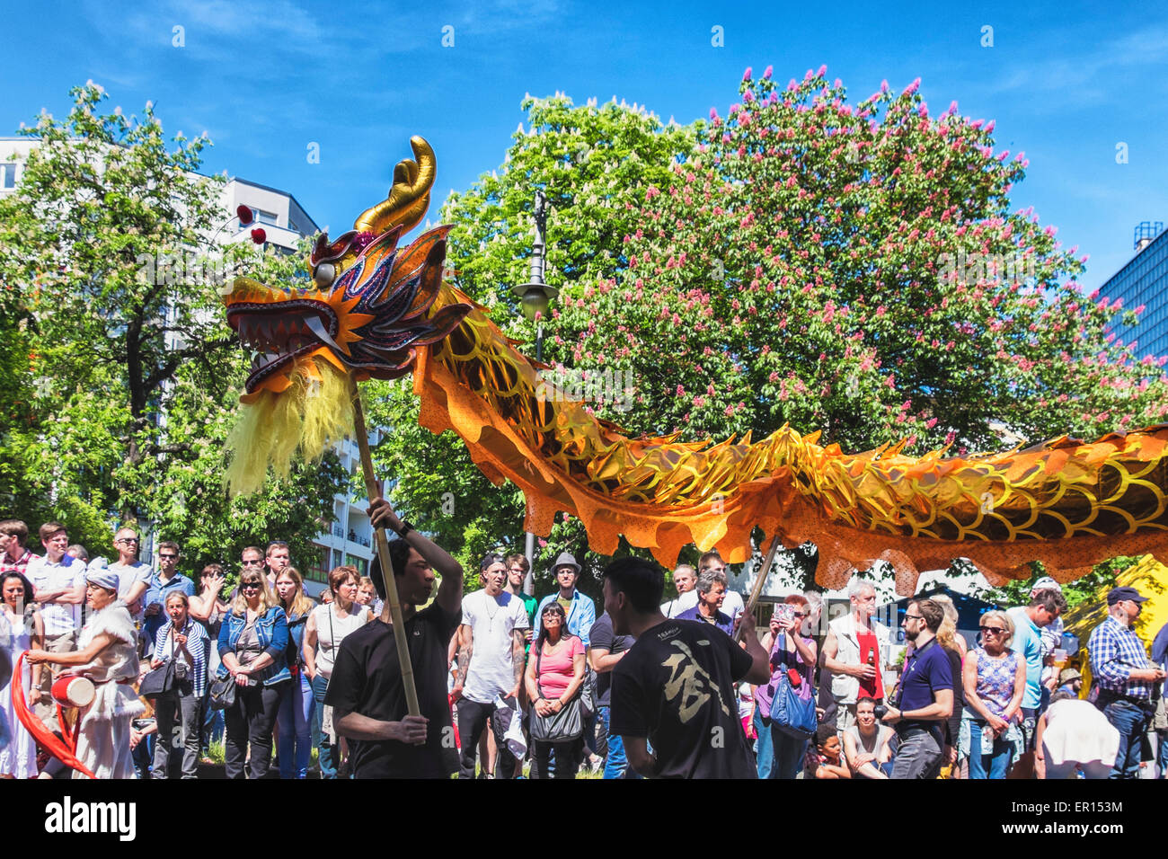 Kreuzberg, Berlin, Allemagne, le 24 mai 2015. Regardez les foules le dragon chinois que Berlin célèbre sa diversité culturelle au Carnaval des Cultures à la Pentecôte chaque année. La grande finale est la street parade le dimanche de Pentecôte où des milliers de danseurs, musiciens et artistes jouent et environ un million de personnes de partout dans le monde montre. Banque D'Images