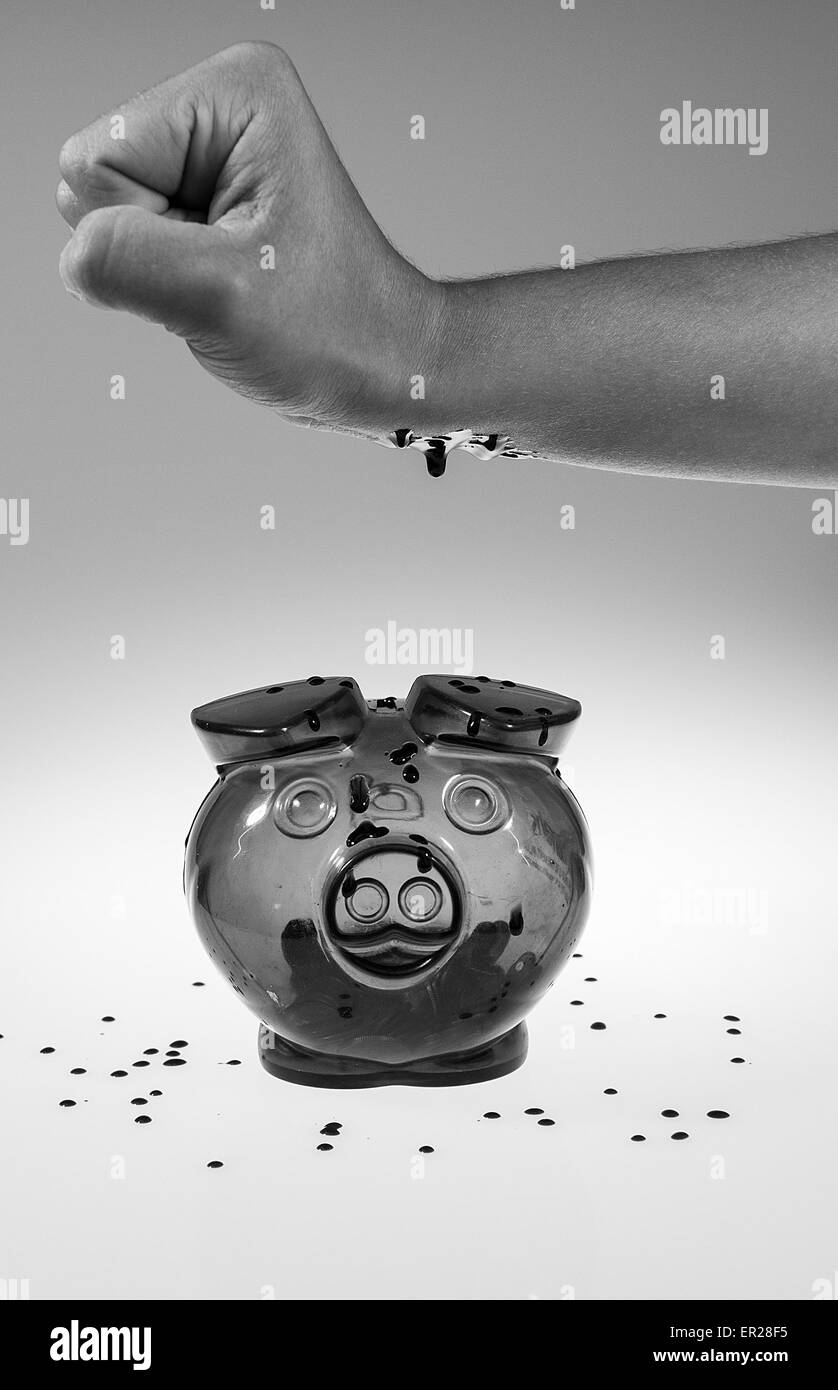 Le sang est des gouttes d'une main dans la tirelire avec gray background Banque D'Images