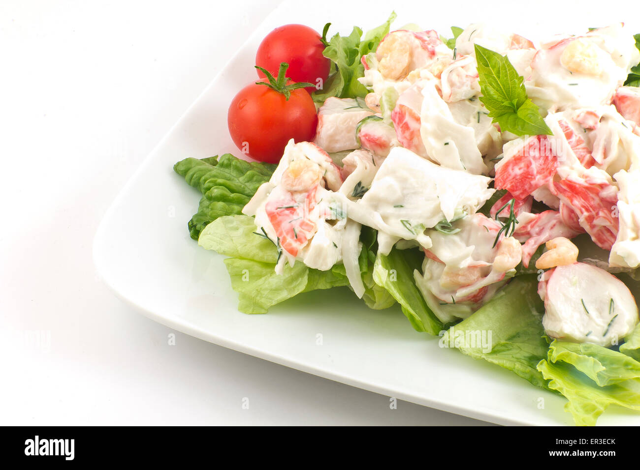 Salade de fruits de mer à la mayonnaise avec les crevettes et la chair de crabe et de l'aneth frais, laitue romaine, et garnir de feuilles de basilic Banque D'Images