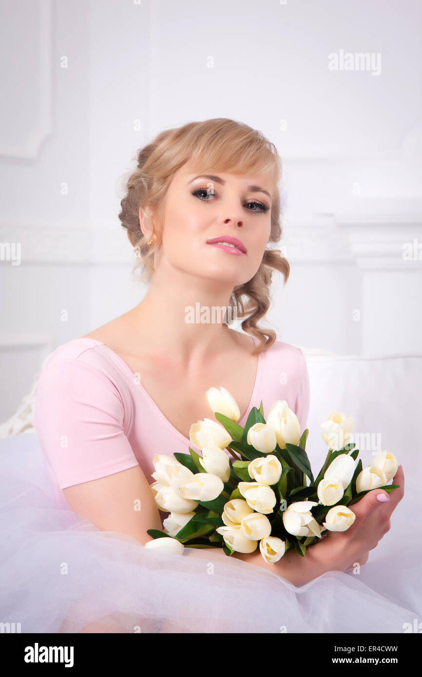 Belle blonde femme avec un bouquet de tulipes Banque D'Images