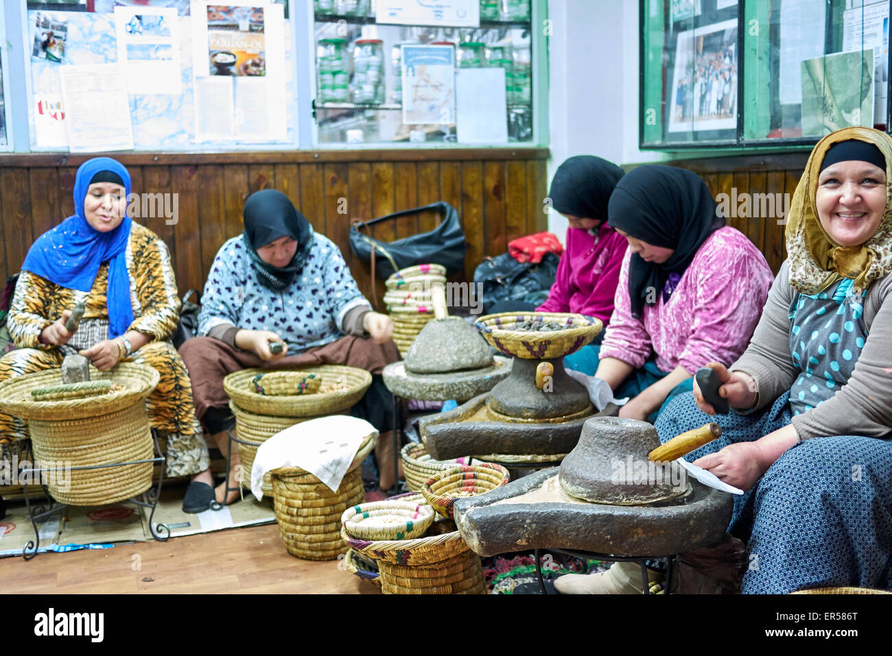 Les femmes berbères argan ouverture les écrous avec les roches, pour se rendre à des noyaux pour la préparation de l'huile d'argan, Anti-Atlas Atlas ou moins Banque D'Images