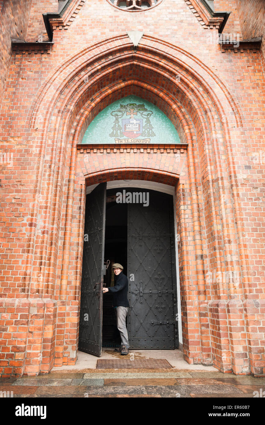 L'homme sort de la porte voûtée du style néo-gothique, la cathédrale de St Florian quartier Praga, Varsovie, Pologne, Europe Centrale Banque D'Images