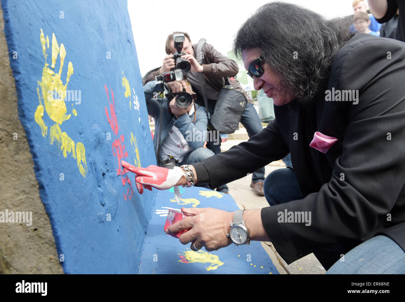 Berlin, Allemagne. 28 mai, 2015. Gene Simmons, le chanteur du groupe de rock américain Kiss décore un morceau du Mur de Berlin avec red handprints et sa signature au FEZ-Berlin, les jeunes enfants, et la famille de Berlin, Allemagne, 28 mai 2015. Simmons dans le monde des défenseurs de l'égard des enfants. Un International Children's Festival aura lieu à FEZ-Berlin du 30 mai au 01 juin 2015. Le groupe Kiss se produira à Berlin le 03 juin 2015. Photo : RAINER JENSEN/dpa/Alamy Live News Banque D'Images