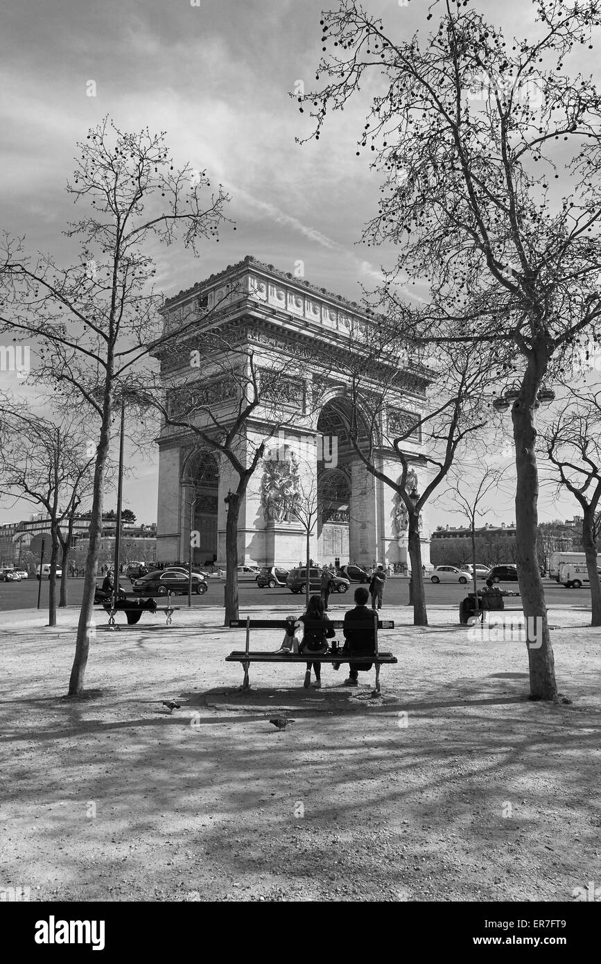 Un couple d'amis assis et regardant vers l'Arc de Triomphe, Paris France Banque D'Images