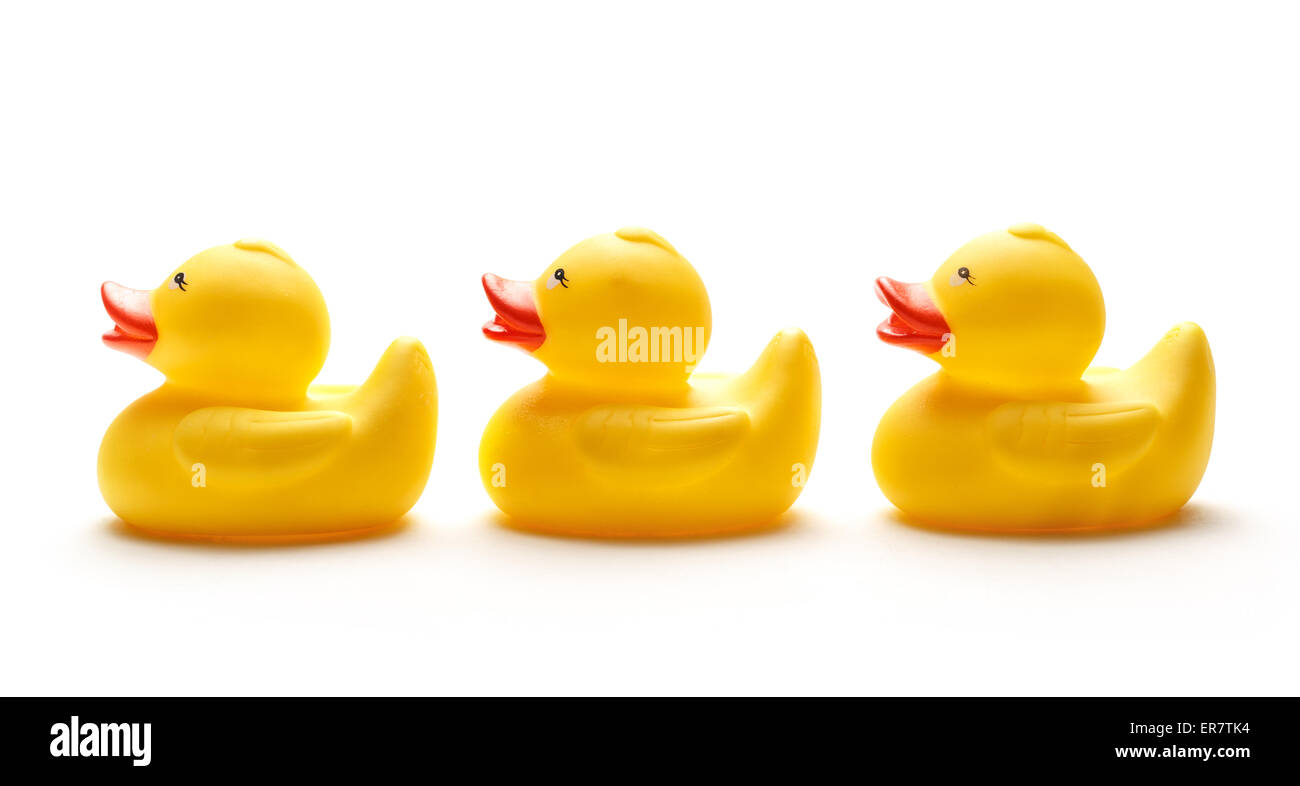 Trois jouets canard jaune sur fond blanc Banque D'Images