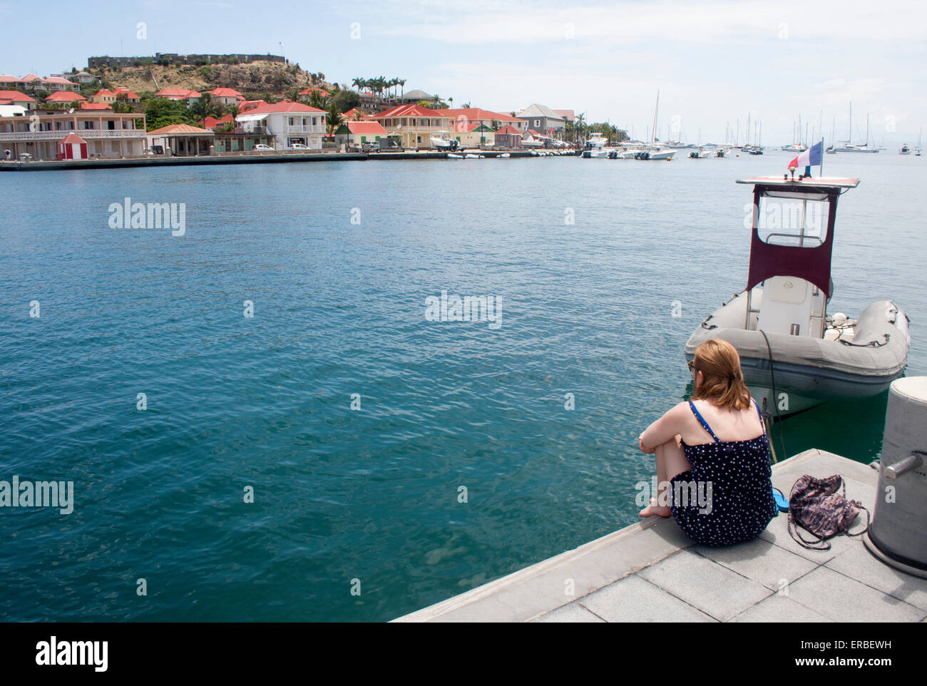 Une jeune femme bénéficie d'une vue sur le port de Gustavia, Saint Barth Banque D'Images