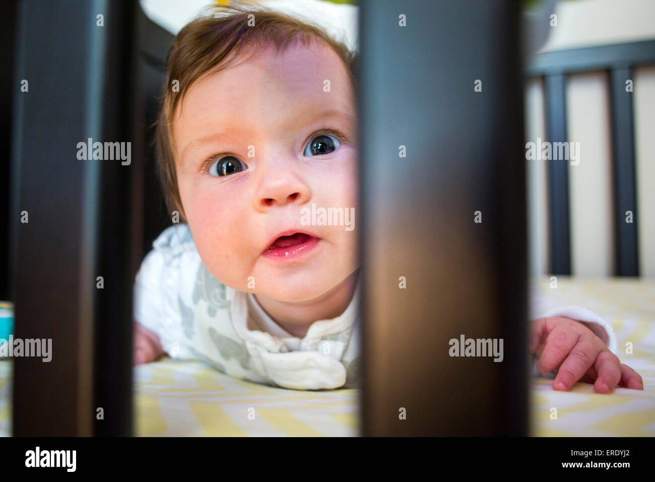 Close up of Caucasian baby girl laying in crib Banque D'Images