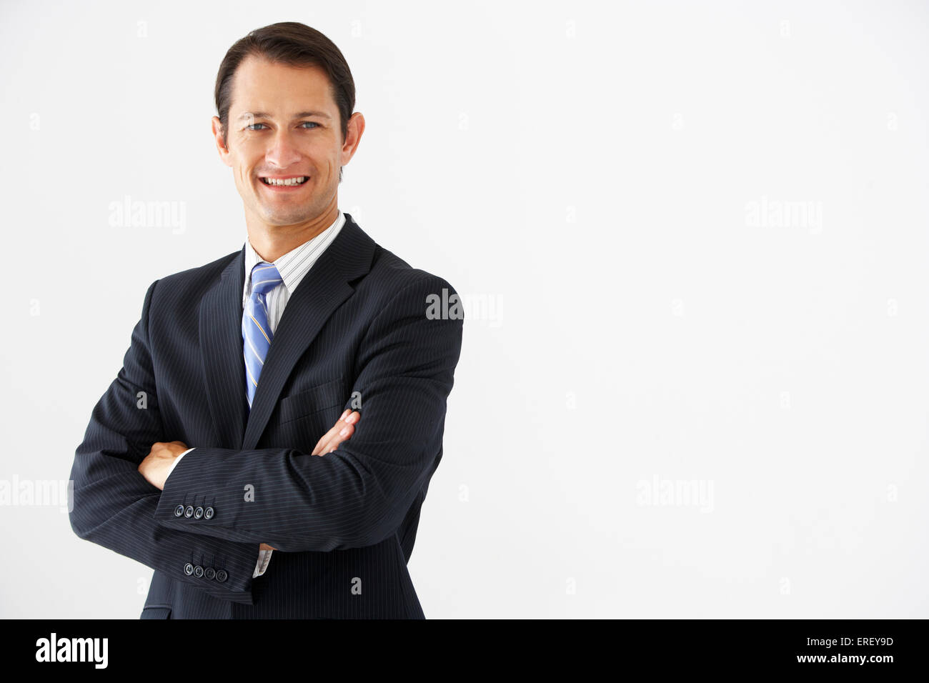 Studio Portrait Of businessman standing Against White Background Banque D'Images