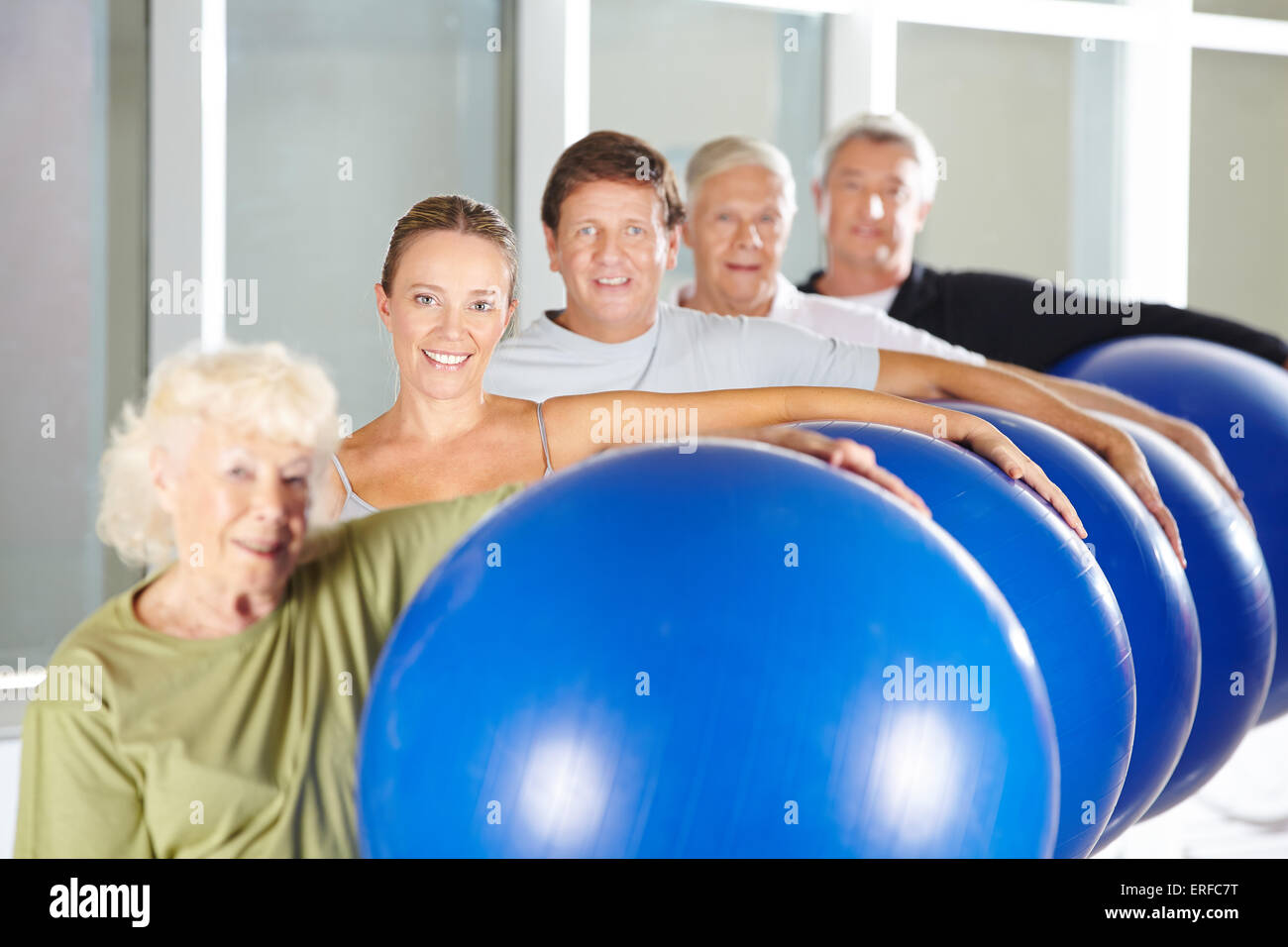 Groupe de personnes âgées faisant de la formation de remise en forme avec salle de sport boules dans Rehab Centre Banque D'Images