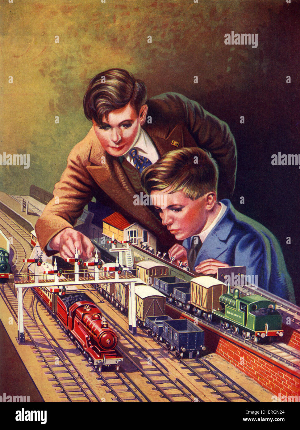 Deux garçons travaillant leur modèle de chemin de fer. Les trains modle tirant les chariots à charbon et un système de signalisation. C. 1938. Artiste inconnu Banque D'Images