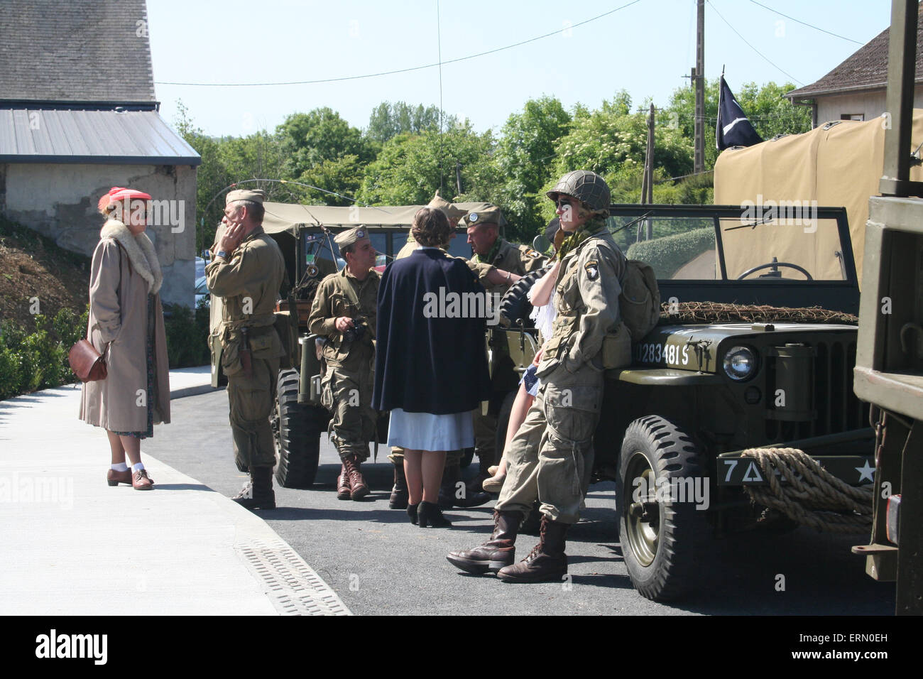 St-Côme-du-Mont, Normandie, France. 4e juin 2015. Tour guides habillés en civils et militaires de la DEUXIÈME GUERRE MONDIALE devant le nouveau D-Day Museum de l'expérience de chaperon le Band of Brothers cast à Carentan pour le déjeuner. Les acteurs ont été les premiers à découvrir le nouveau musée sur le jour de son ouverture (4 juin 2015). Le point fort du nouveau musée est un vrai C-47, qui mettait en vedette dans la série Band of Brothers, et a été transformé en simulateur de vol. © Daniel et Blanc Flossie/Alamy Live News Crédit : Daniel et Blanc Flossie/Alamy Live News Banque D'Images