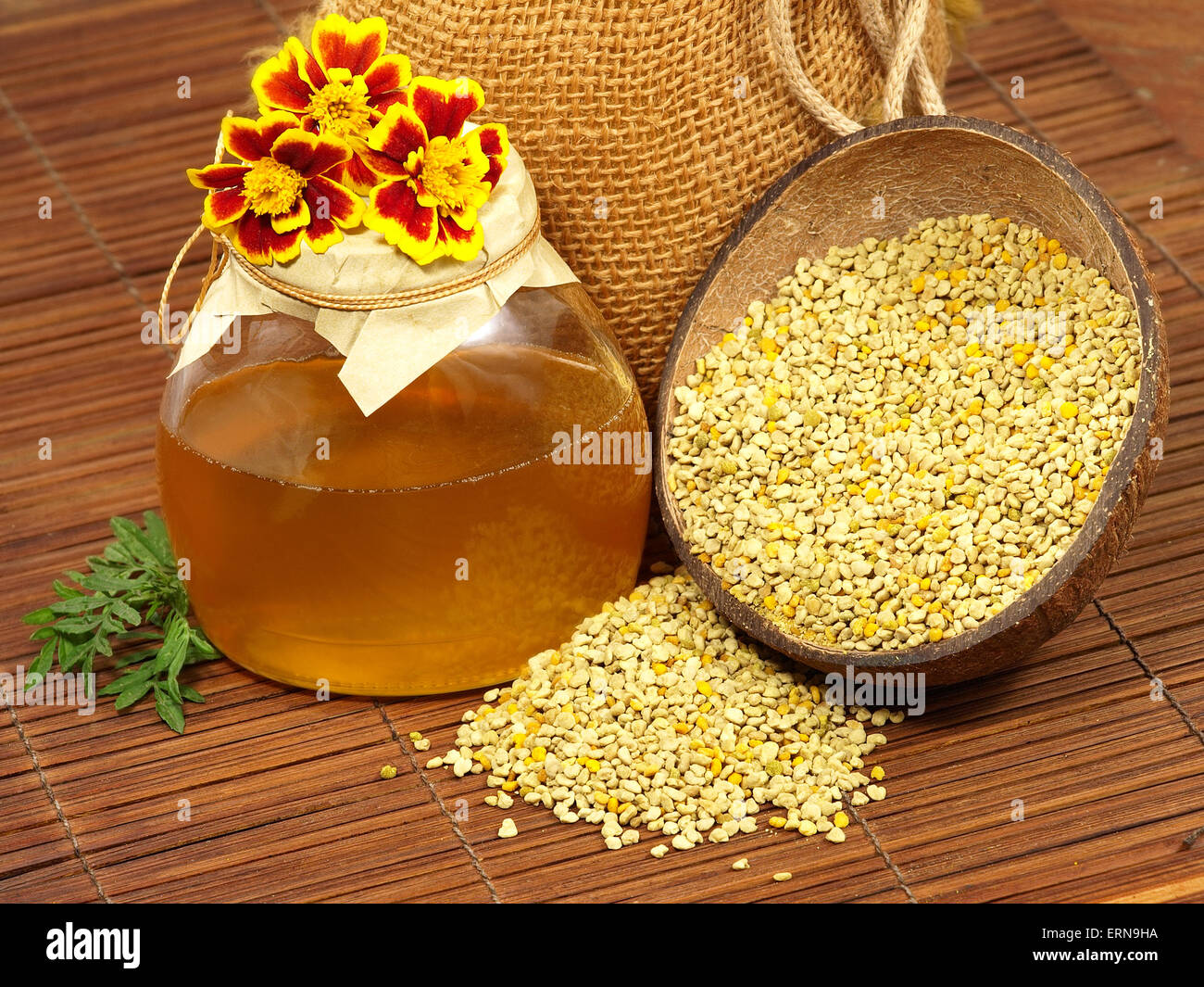 Pot de miel,fleurs jaunes et du pollen sur une surface en bois. Banque D'Images