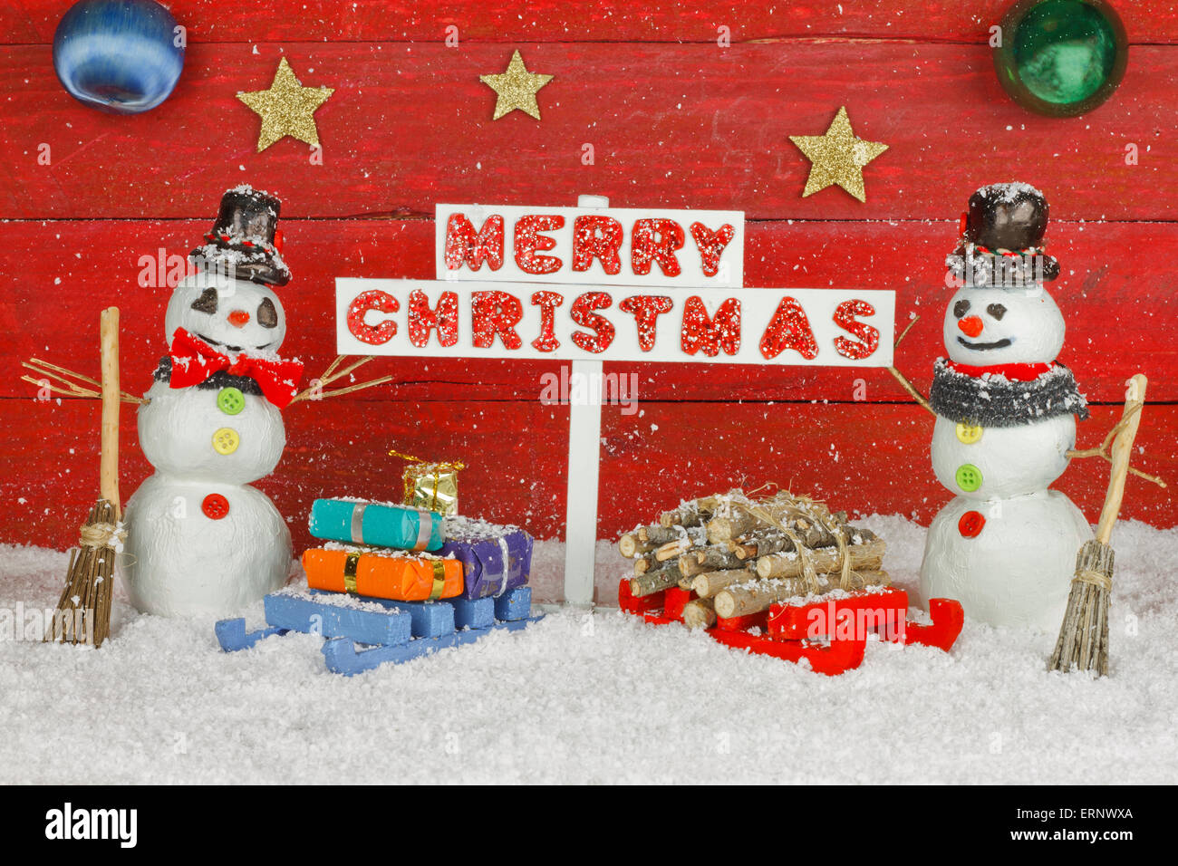 Deux Bonhommes Tenant Une Pancarte Avec Les Mots Joyeux Noel Sur Fond Rouge Photo Stock Alamy