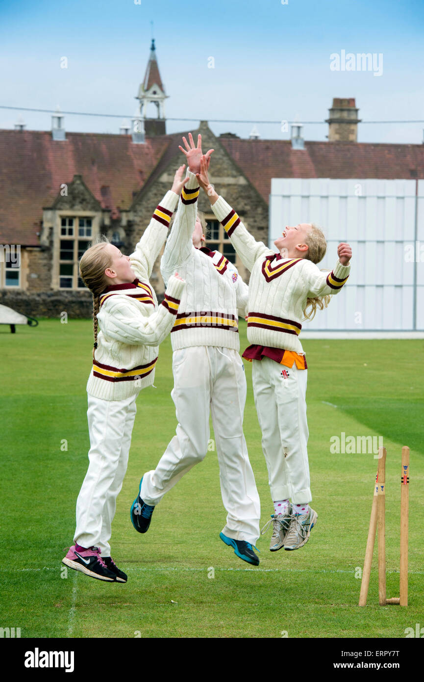 Junior Filles célèbrent en tenant un guichet pendant un match de cricket dans le Wiltshire, Angleterre Banque D'Images