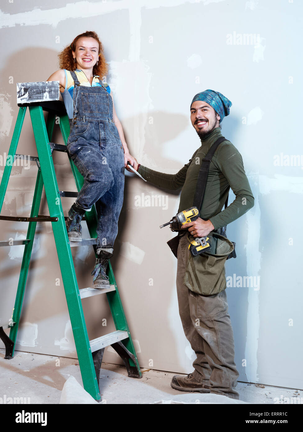 Portrait of a smiling young couple rénover, réparer drywall Banque D'Images