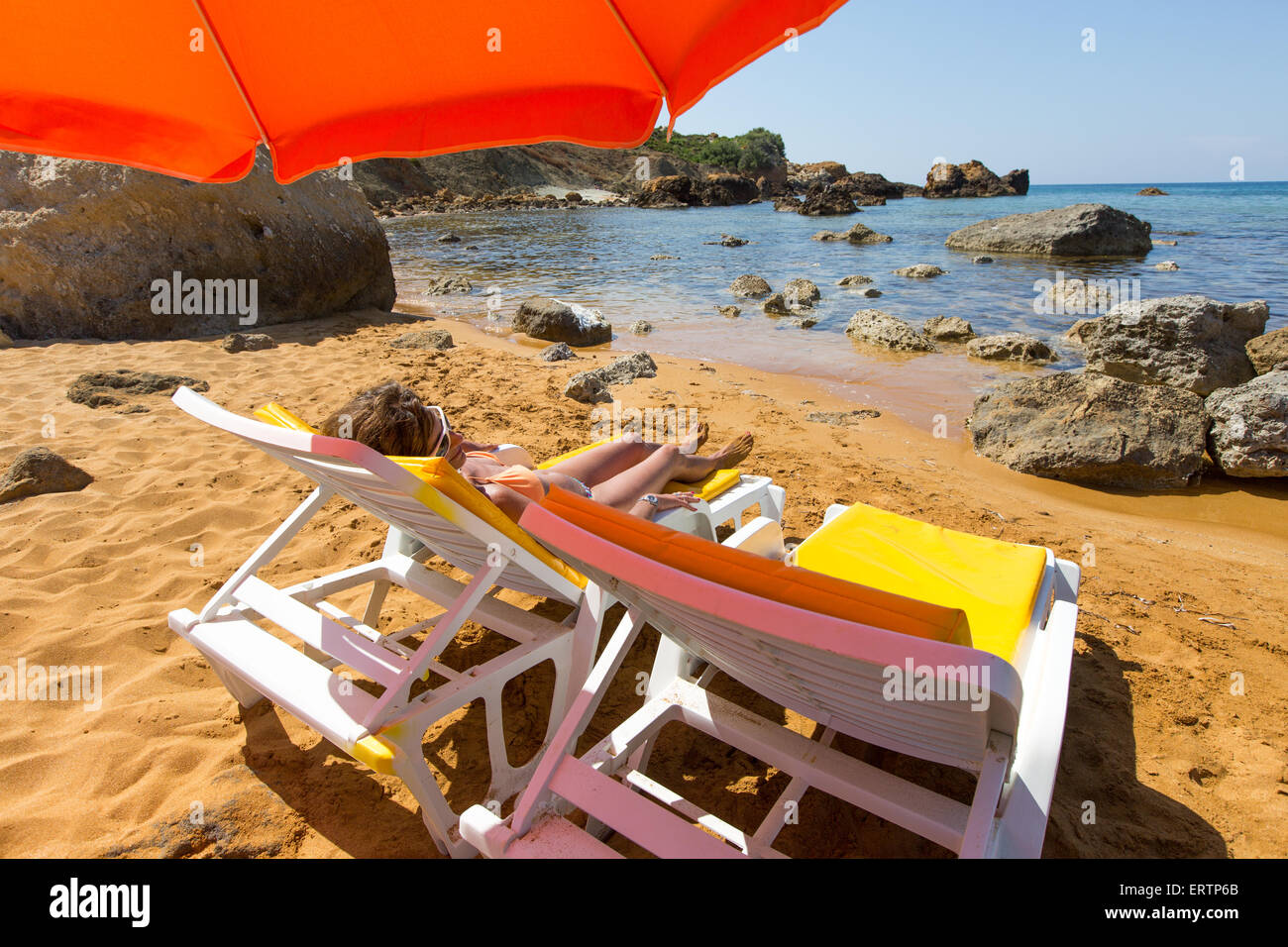 Femme couchée sous un parasol dans la baie de San Blas l'île de Gozo, à  Malte Photo Stock - Alamy