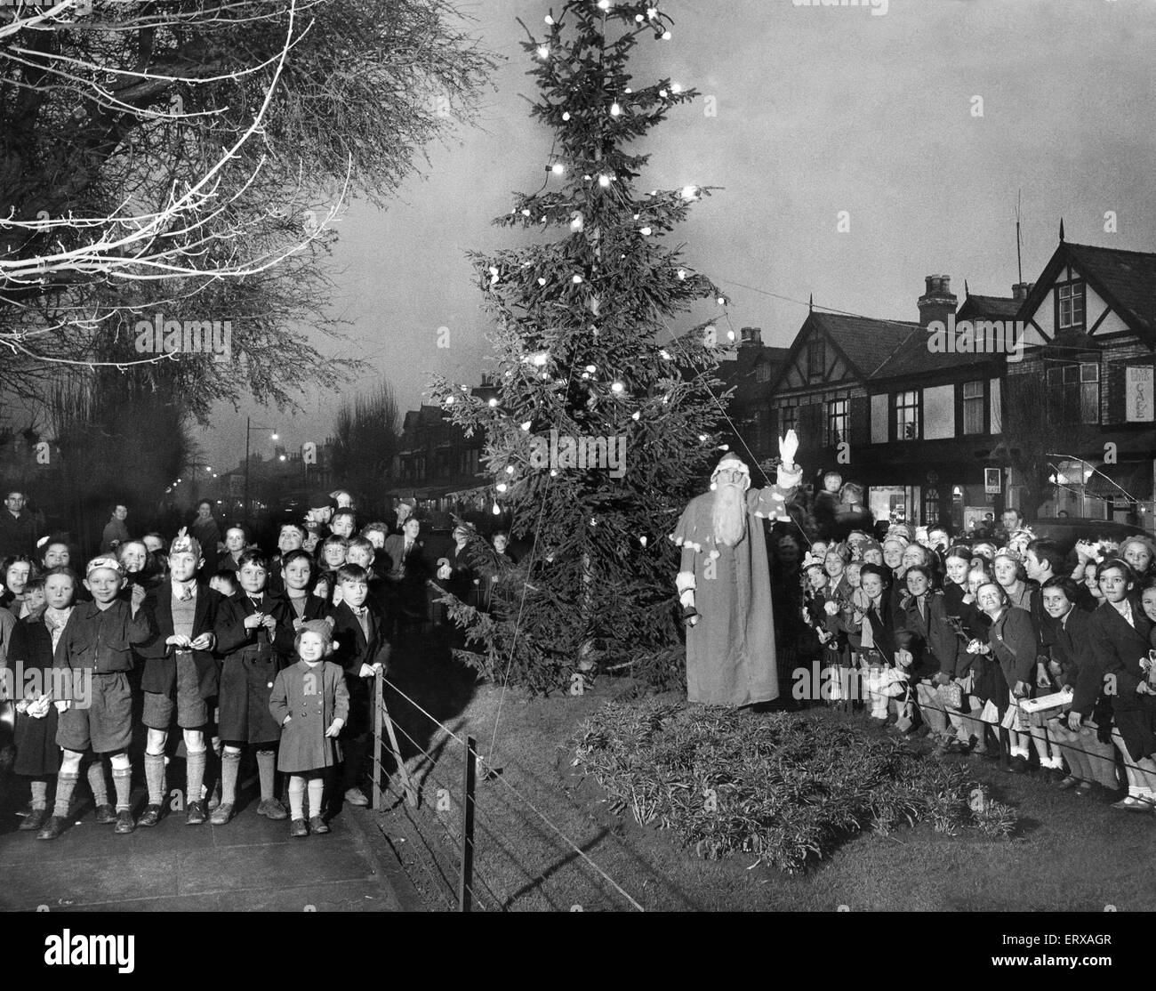 Le Père Noël des enfants de l'école conduit à carol chant autour de l'arbre de Noël du Conseil sur Market Street, Liverpool Hoylake,. 23 Décembre 1953 Banque D'Images