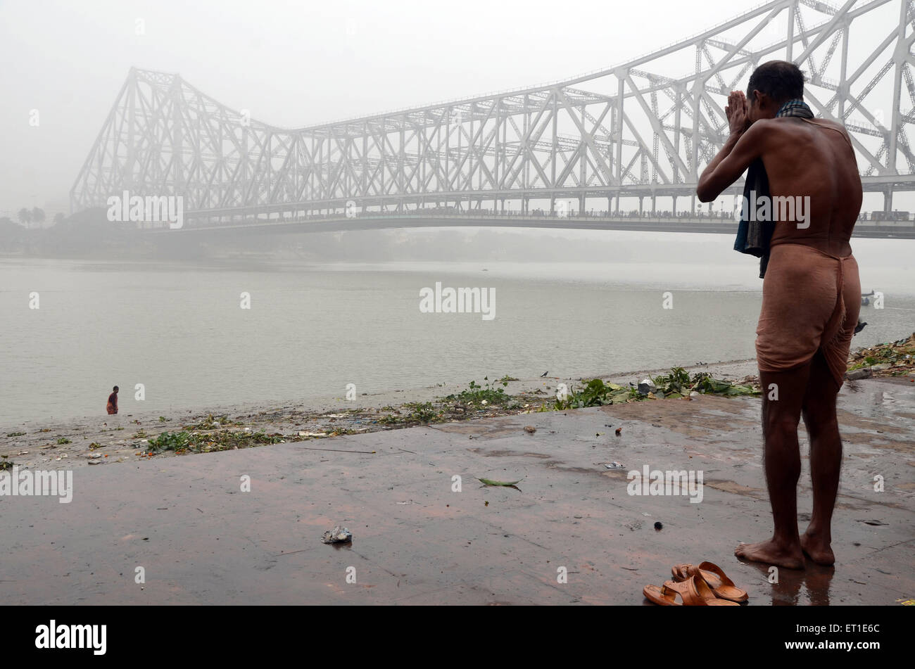 Homme qui prie Hooghly river Makar Sankranti Kolkata West Bengale Inde Asie Banque D'Images