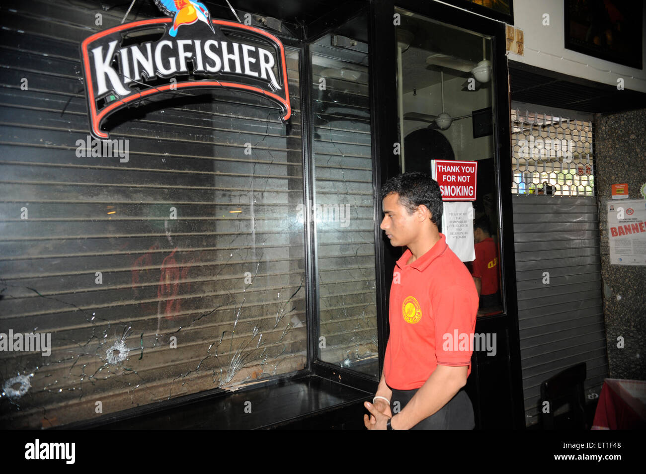 Leopold Cafe waiter showing blessure par balle sur le verre ; après une attaque terroriste par Deccan Mujahideen le 26 novembre 2008 à Bombay Banque D'Images