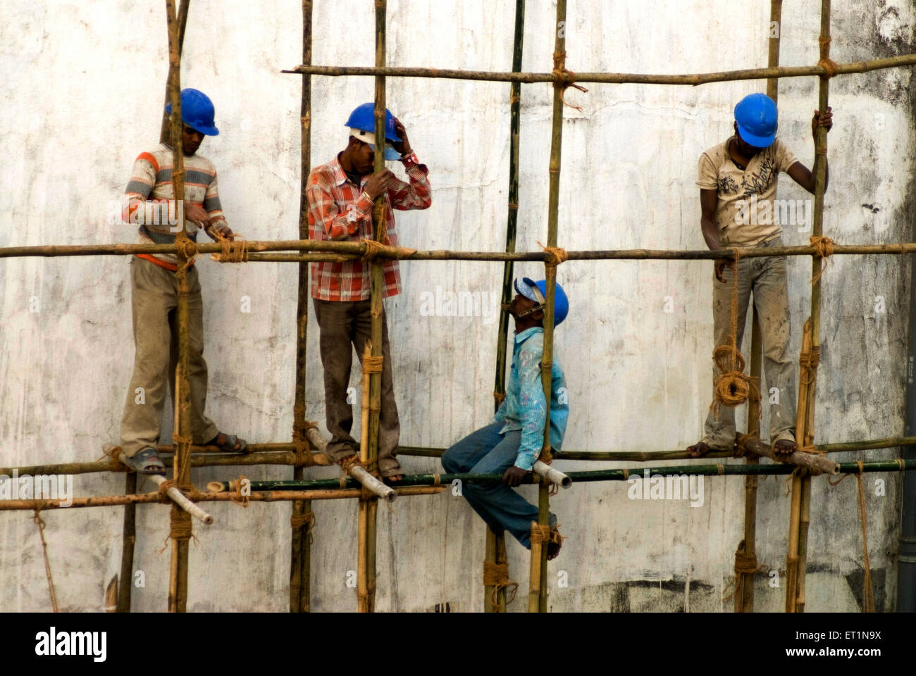 Les travailleurs de la construction les bambous de liage avec corde Banque D'Images