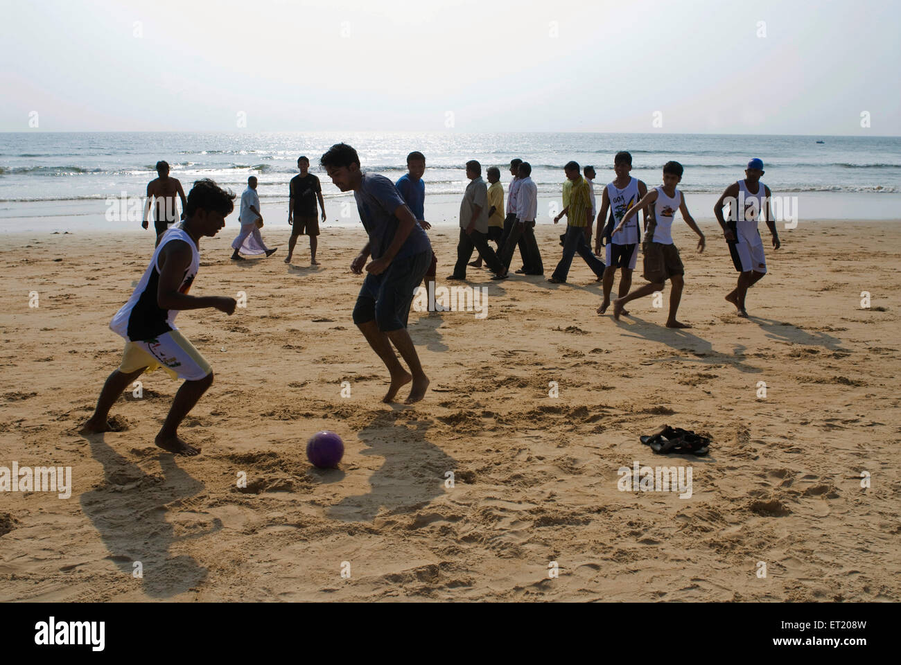 Touristes jouant au football à la plage de Candolim ; Goa ; Inde , asie Banque D'Images
