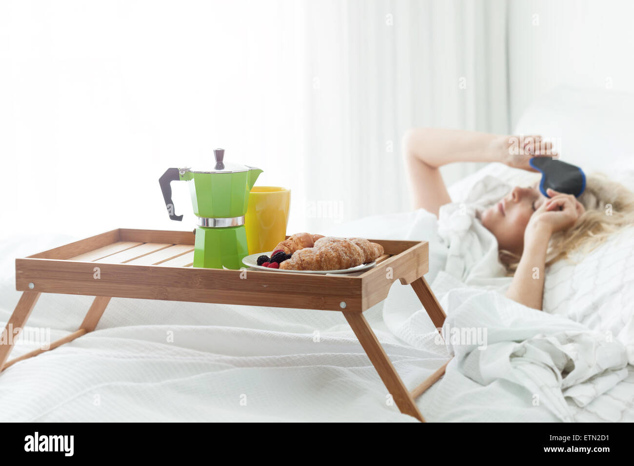 Plateau de bois de petit-déjeuner avec café et croissant sur lit. Surprise romantique pour se réveiller avec les yeux de la femme Banque D'Images Plateau de bois de petit-déjeuner avec café et croissant sur lit. Surprise romantique pour se réveiller avec les yeux de la femme Banque D'Images