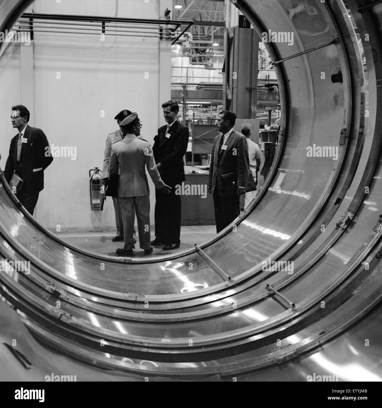 Cette photographie capture une visite d'usine VIP de 1960 pour des journalistes britanniques, offrant un aperçu des processus industriels au milieu du XXe siècle. La visite met en évidence les principales techniques de fabrication et innovations de cette époque. Banque D'Images