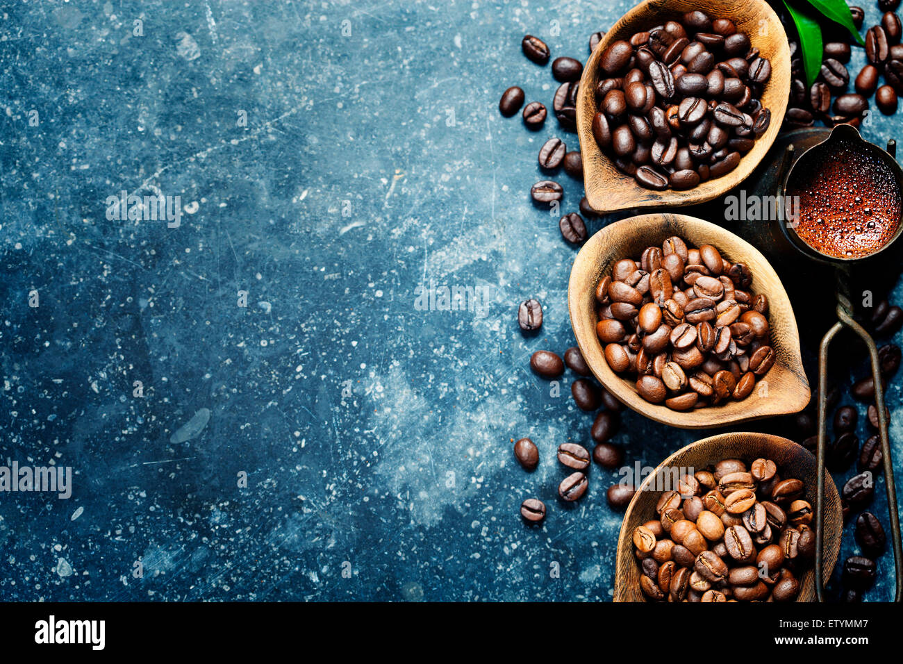 Vue du haut de trois différentes variétés de grains de café sur fond foncé vintage Banque D'Images
