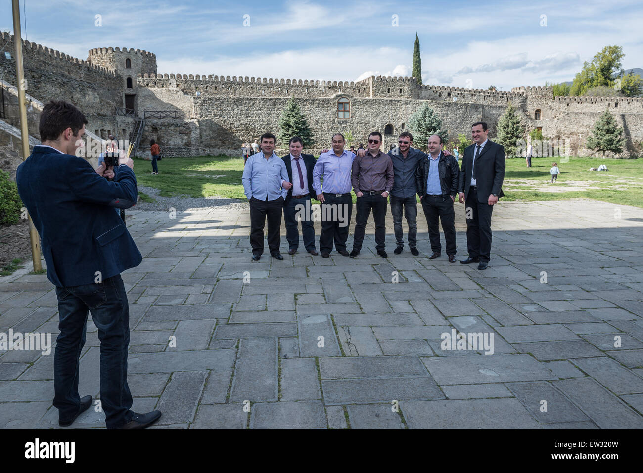 Groupe d'invités du mariage pose pour la photo en face de Svetitskhoveli (pilier) vivant en ville la cathédrale de Mtskheta (Géorgie) Banque D'Images