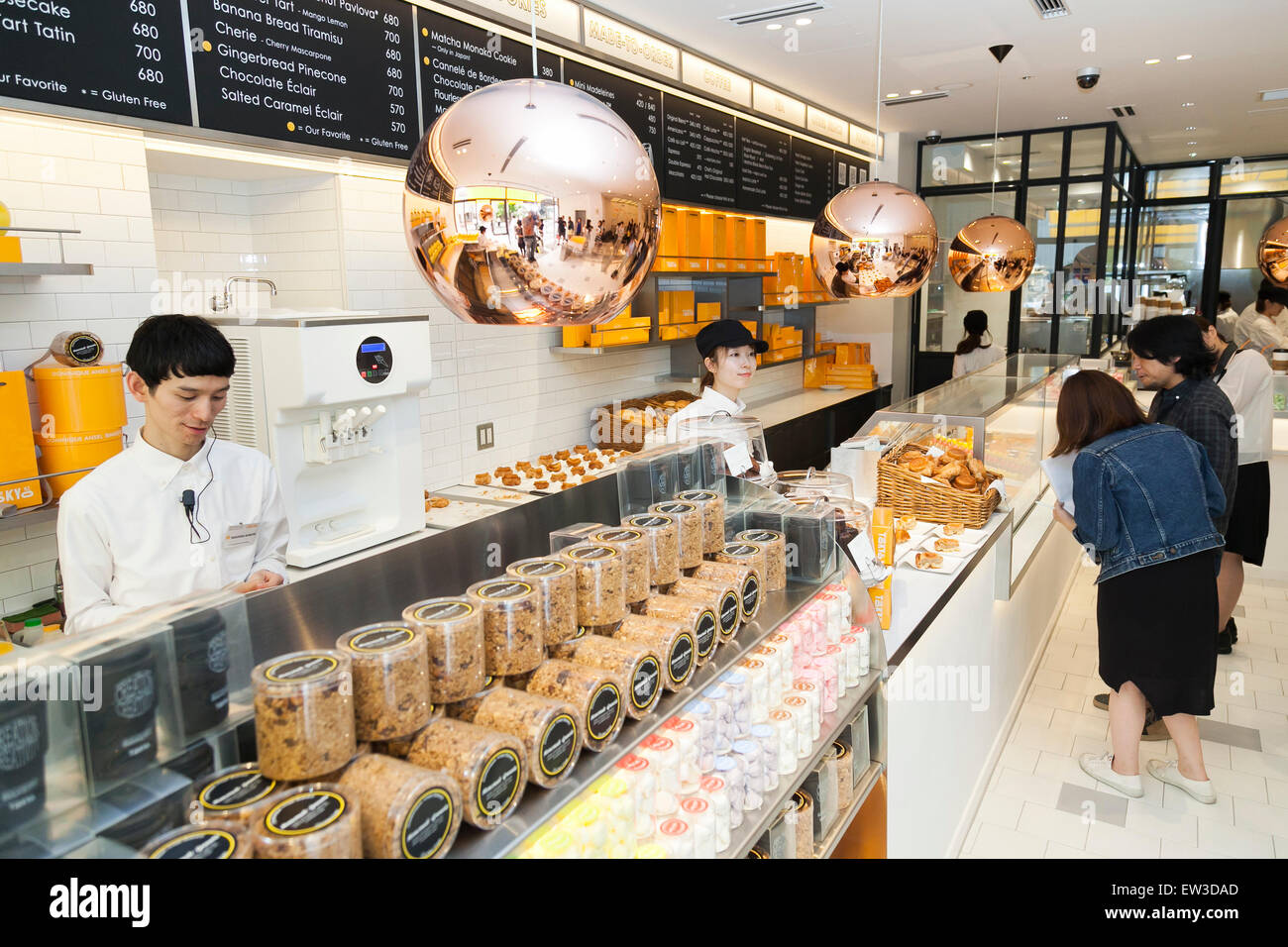 Personnel de la nouvelle pâtisserie ''Dominique Ansel Bakery'' prendre des commandes à partir de la presse membres durant la phase pré-événement d'ouverture pour la première boulangerie magasin japonais situé dans Omotesando Hills le 17 juin 2015, Tokyo, Japon. La nouvelle marque est connue pour ses pâtisseries Cronuts ; un croissant doughnut création fusion par le Chef Dominique Ansel et est déjà très populaire à New York. C'est la première fois qu'il ouvrira une succursale internationale. Le Japon a connu un boom récent dans les détaillants alimentaires surtout d'essayer d'être la dernière nouvelle tendance à Tokyo. Le magasin ouvre ses portes à la population le Ju Banque D'Images