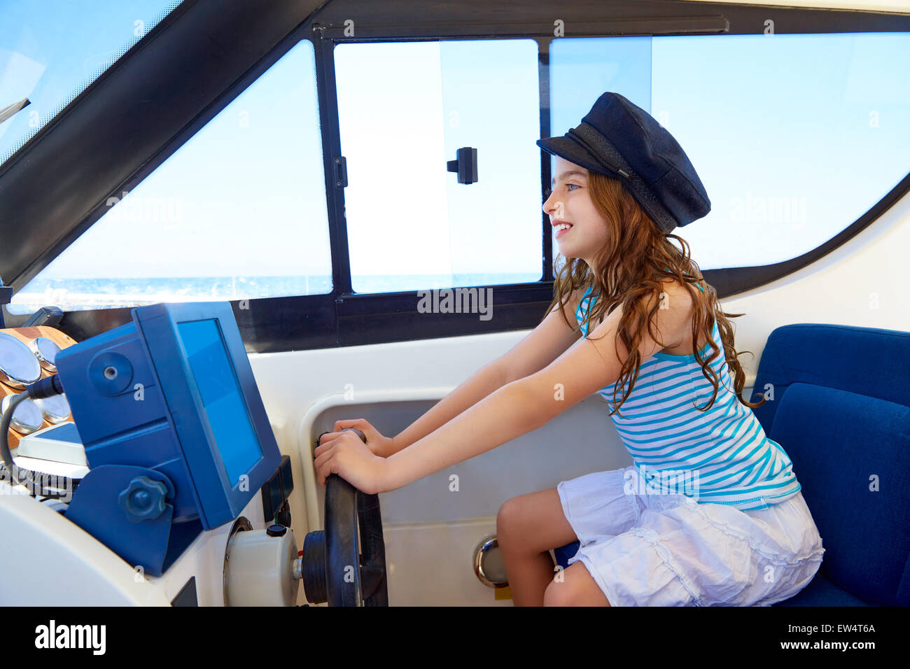 Kid girl prétendant être un capitaine marin bateau dans la roue intérieure holding Banque D'Images