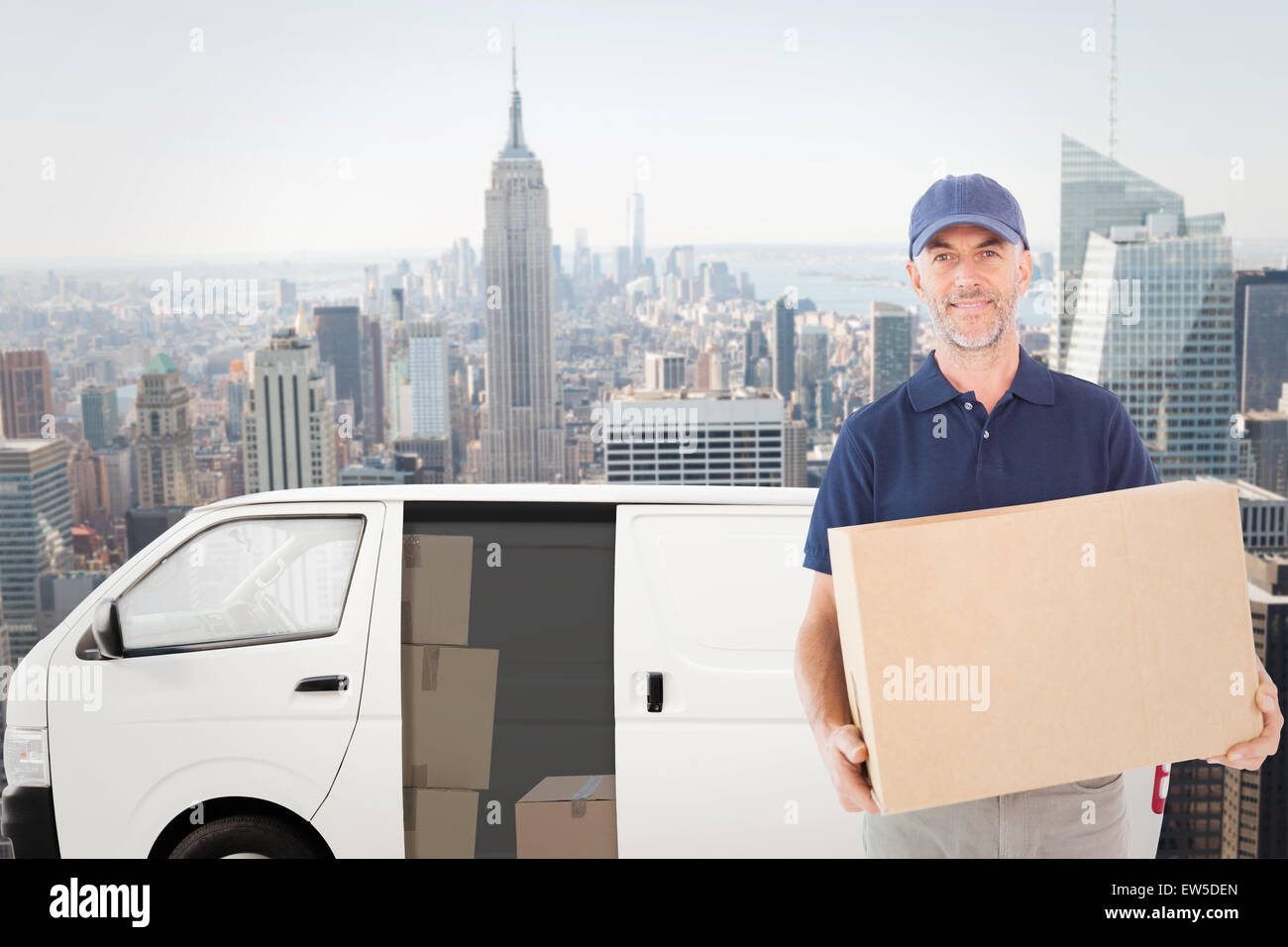 Composite image of delivery man holding cardboard box Banque D'Images