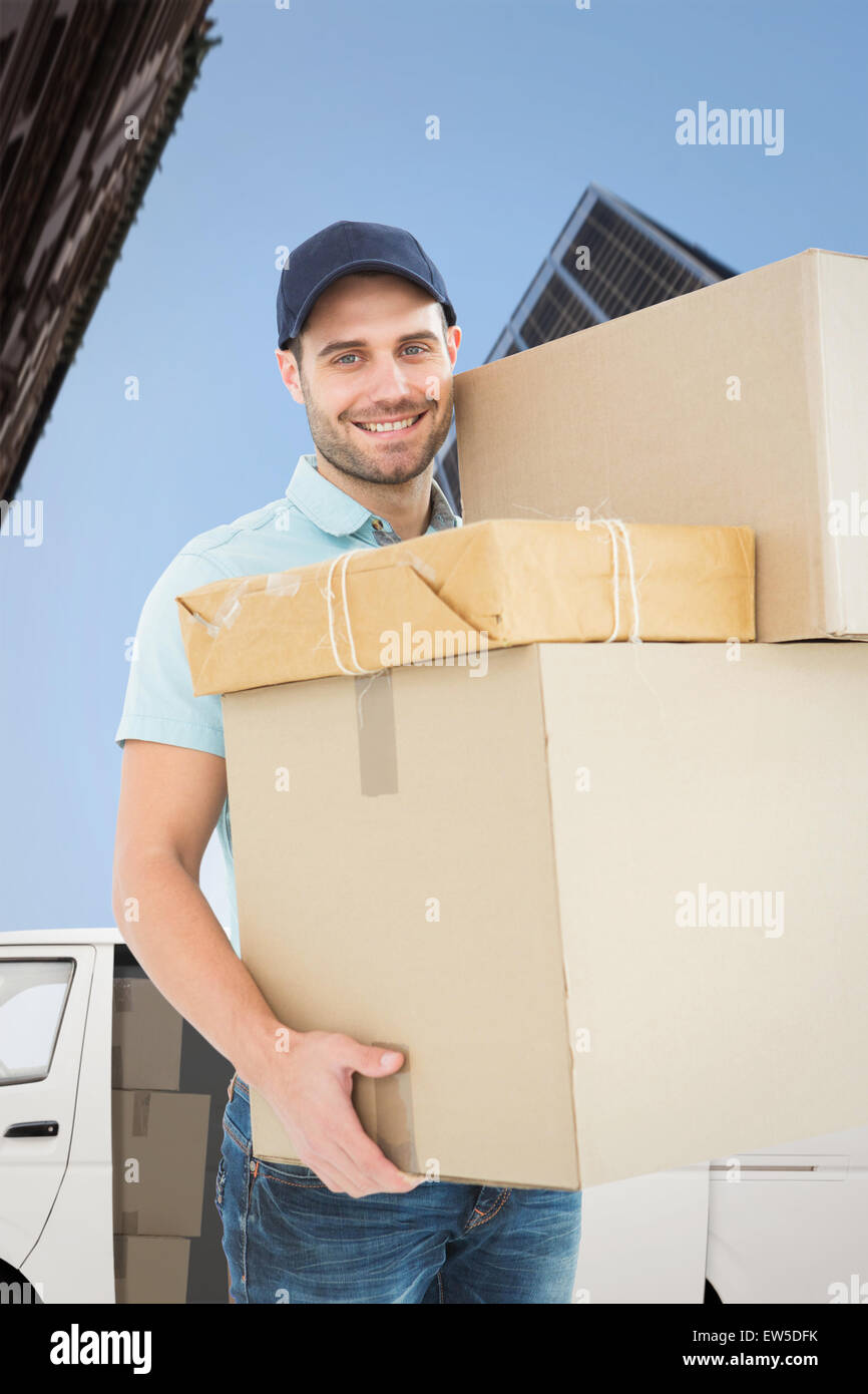 Composite image of delivery man carrying cardboard boxes Banque D'Images