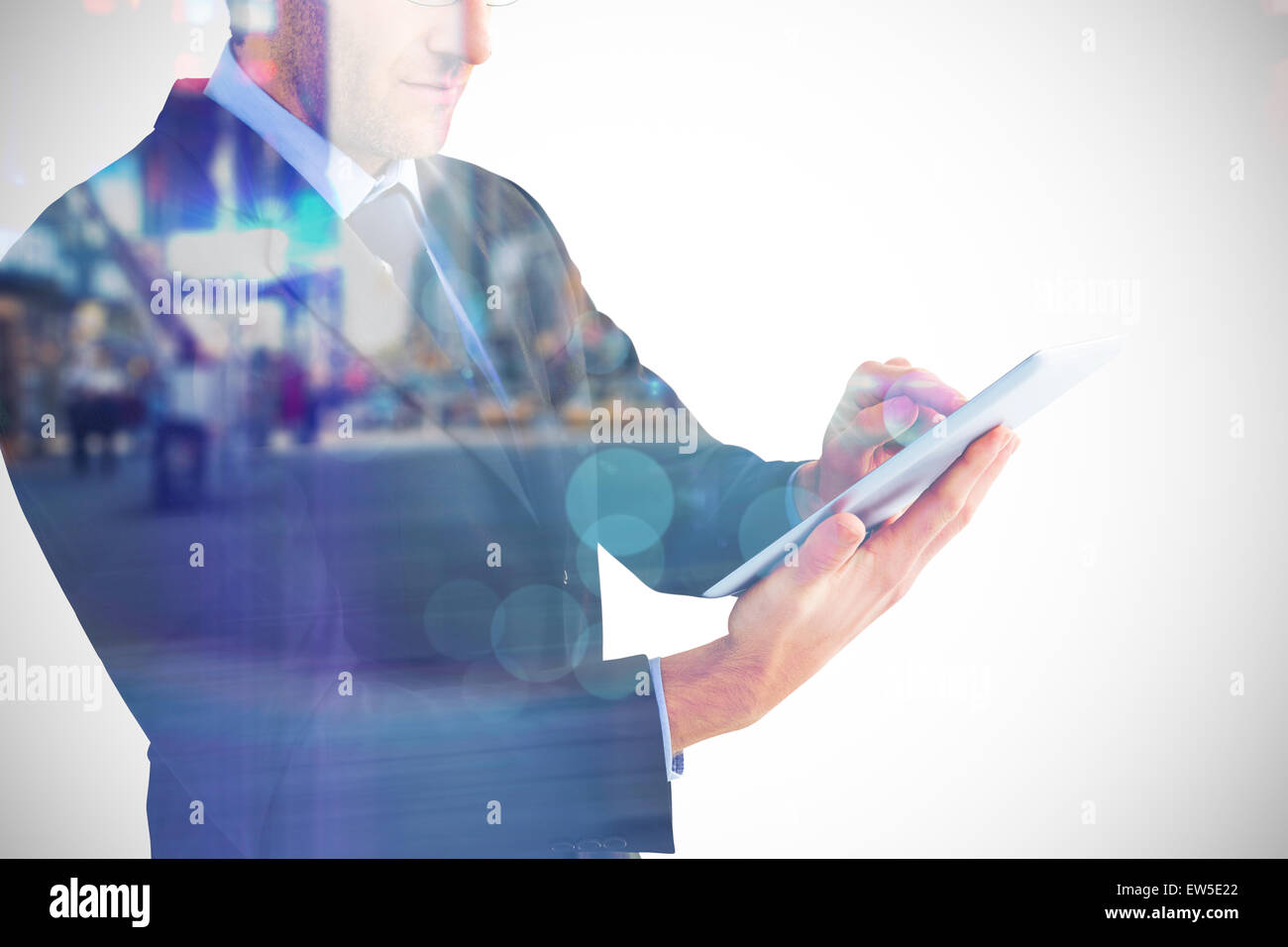 Image composite de mid section of a businessman using digital tablet Banque D'Images