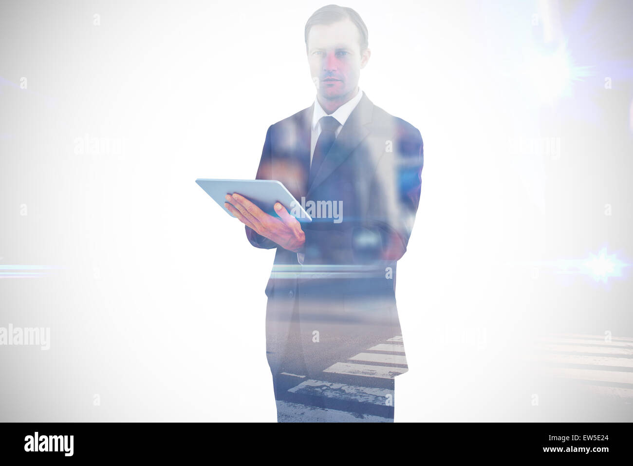 Composite image of businessman charismatique holding a tablet computer Banque D'Images