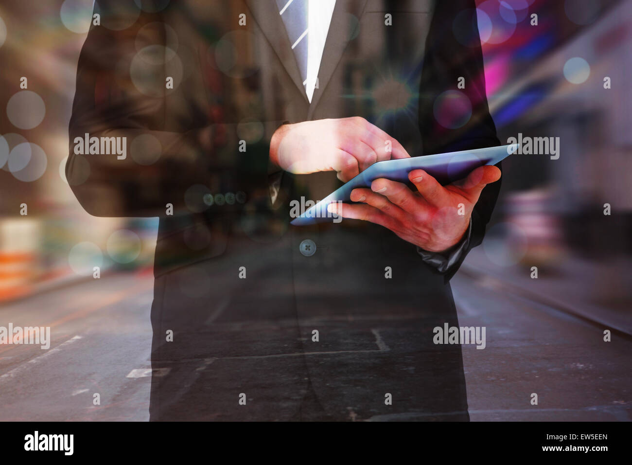 Image composite de businessman touching his tablet pc Banque D'Images