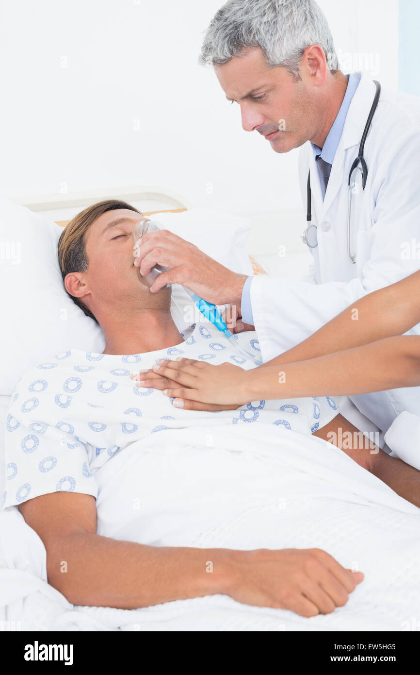 Médecin mettre un masque à oxygène Banque D'Images