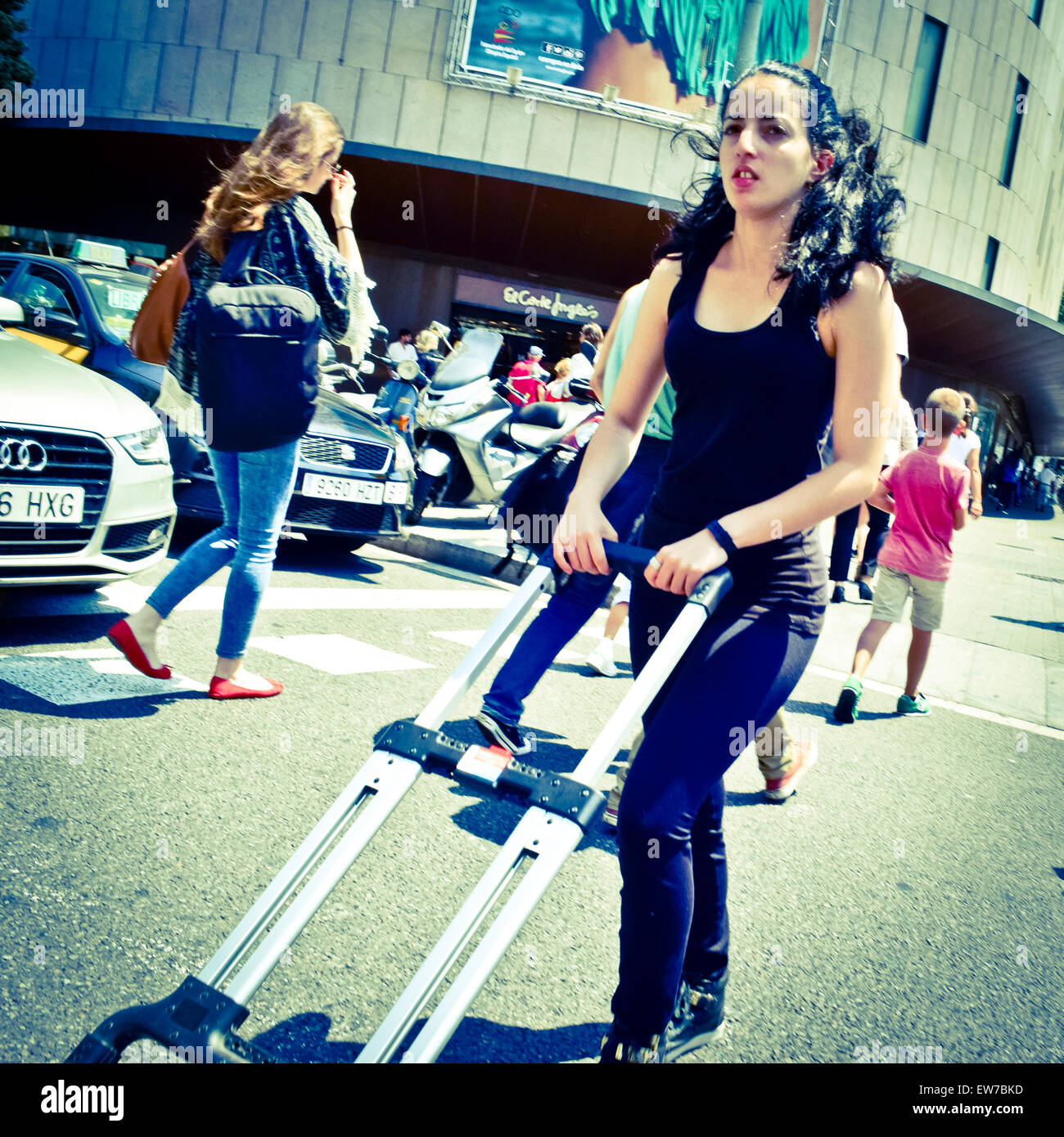 Une jeune femme en poussant une brouette. Barcelone, Catalogne, Espagne. Banque D'Images