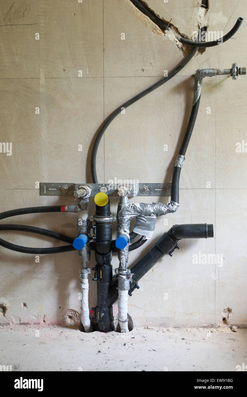 Plomberie inachevé / eau et raccords de purge à l'intérieur d'un chantier de construction (où l'évier de la cuisine va être) Banque D'Images