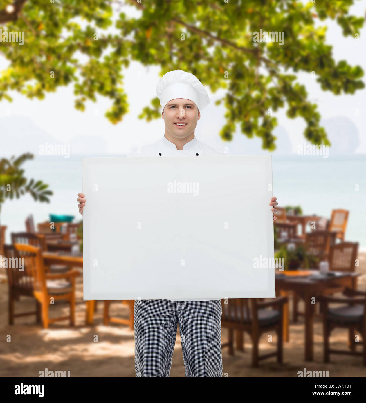 Happy male chef cook holding white blank big board Banque D'Images