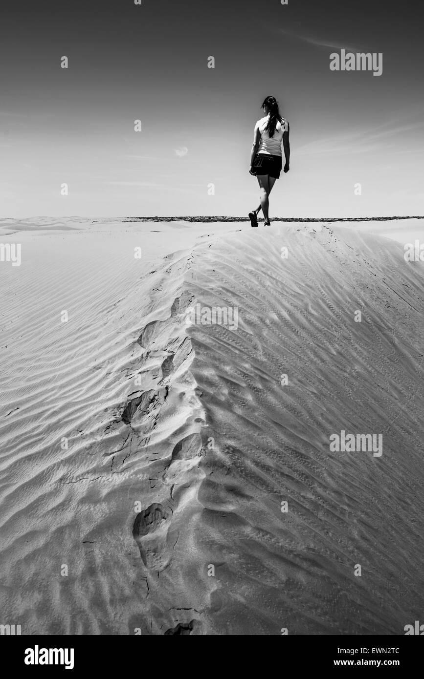 Femme marche sur le désert photo en noir et blanc Banque D'Images