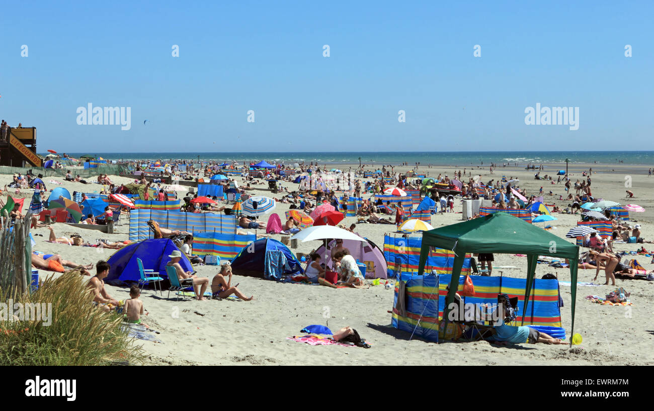 West Wittering Beach, West Sussex, UK. 30 Juin, 2015. Sur la journée la plus chaude de l'année, la température atteignait 26 degrés sur la côte sud de West Wittering. Des milliers d'adorateurs du soleil prendre à la plage de sable avec une douce brise et des ciels bleus faire une journée parfaite. Credit : Julia Gavin UK/Alamy Live News Banque D'Images