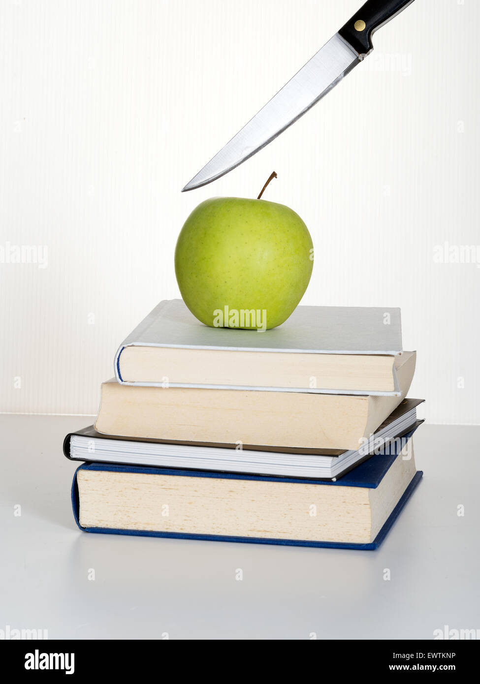 Réductions éducation métaphore. A propos de couteaux à découper en Apple de l'enseignant. Banque D'Images