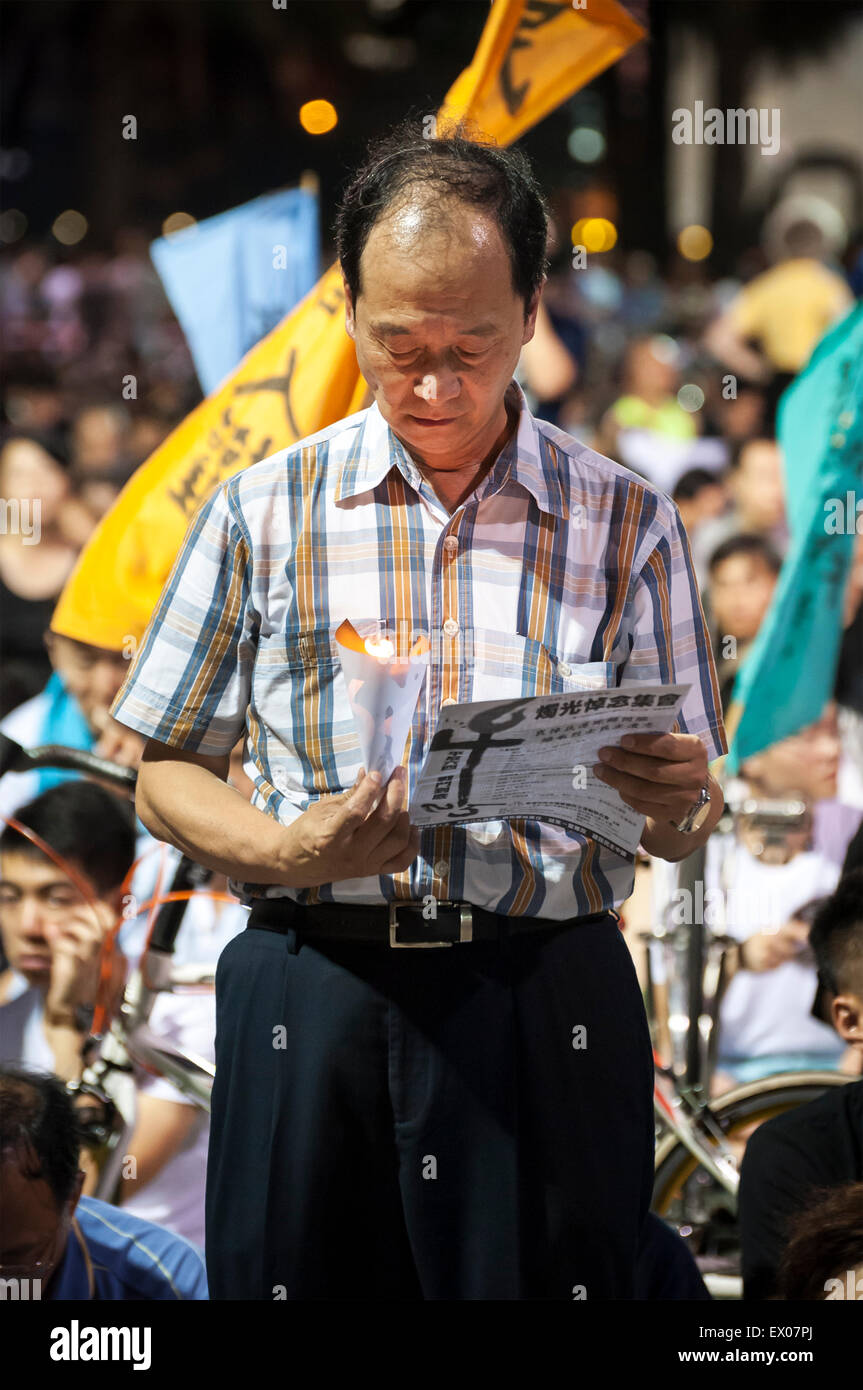 Un homme tient une bougie à une veillée aux chandelles commémorant l'anniversaire de la Place Tienanmen Banque D'Images