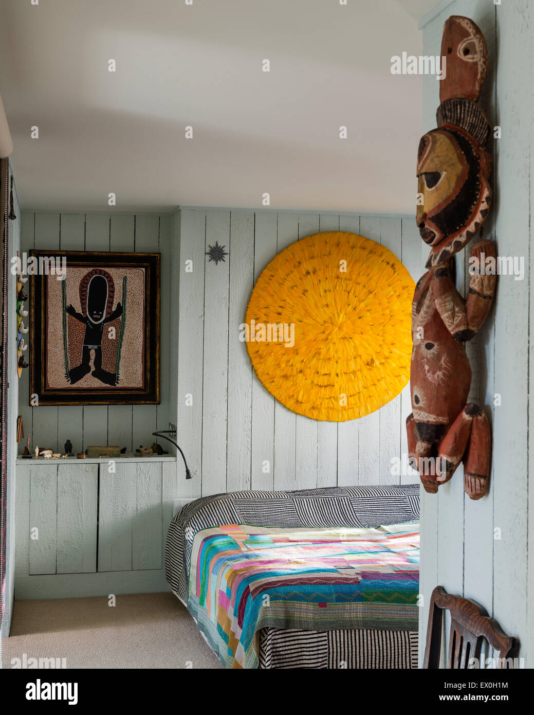 Une plume jaune mandala fait par le designer Simon Costin au-dessus de lit dans la chambre avec la peinture par l'artiste autochtone David Downs. Banque D'Images
