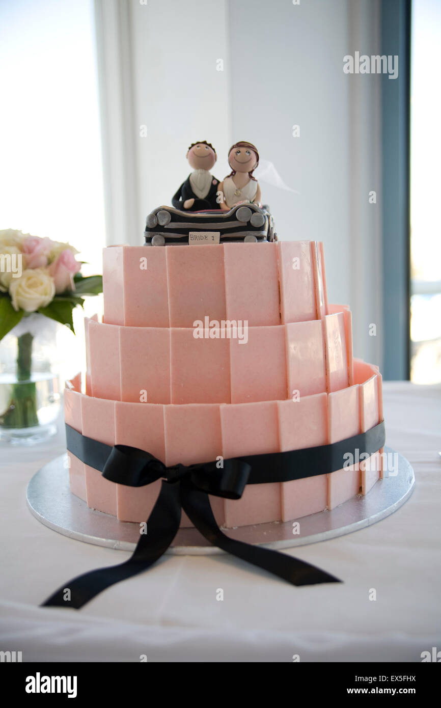 Gâteau de mariage décoré avec des figurines mariés dans une voiture décapotable Banque D'Images